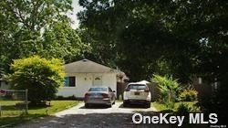 87 Flower Road Mastic Beach, NY 11951 - Photo 1 of 1 a front view of a house with garden