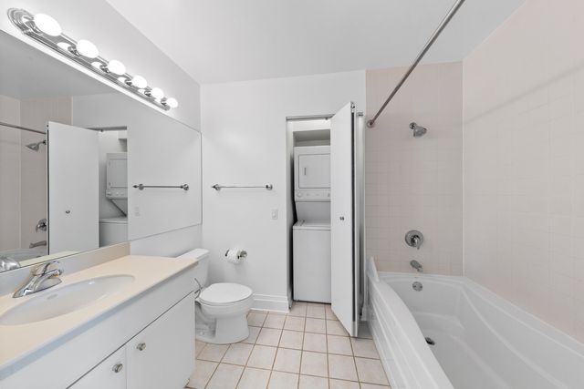 a living room with furniture a flat screen tv and a large window