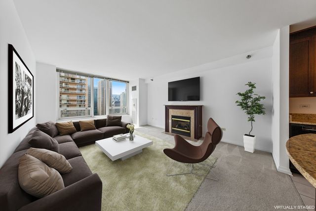 a view of kitchen with wooden floor and a fireplace