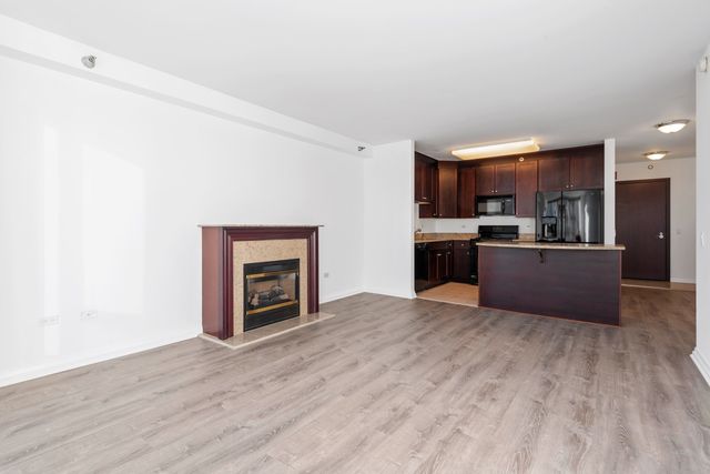 a kitchen with a sink counter top space cabinets and stainless steel appliances