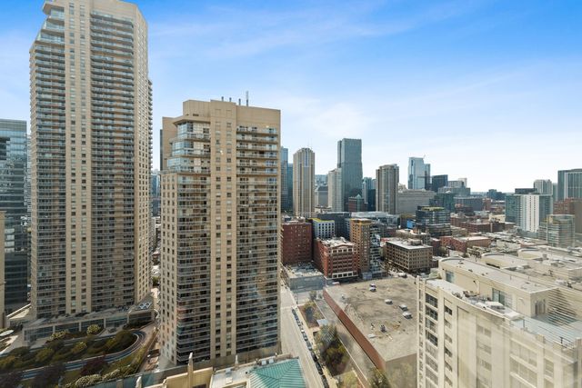 a bedroom with bed and a large window