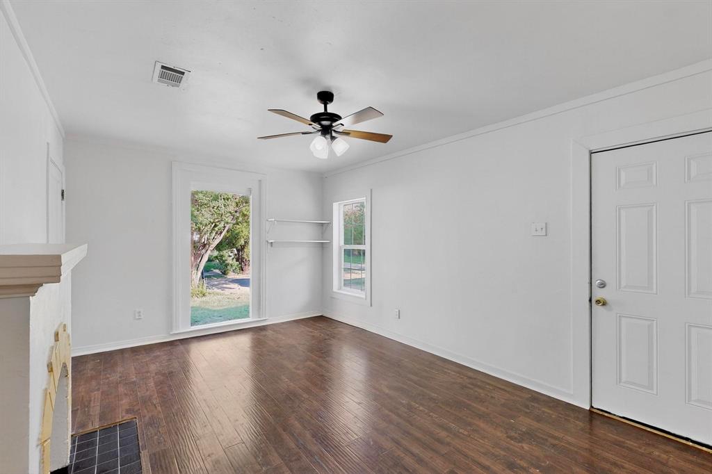 5020 Pershing Street Dallas, TX 75206 - Photo 14 of 30 a view of an empty room with a window and wooden floor