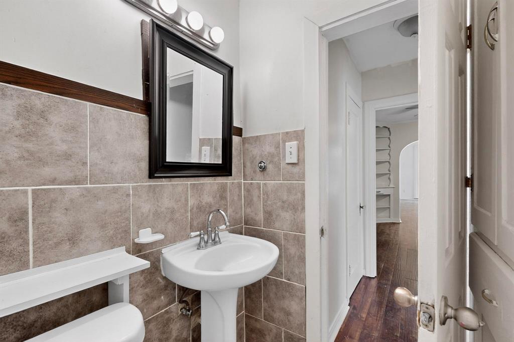 5020 Pershing Street Dallas, TX 75206 - Photo 18 of 30 a bathroom with a sink mirror and toilet
