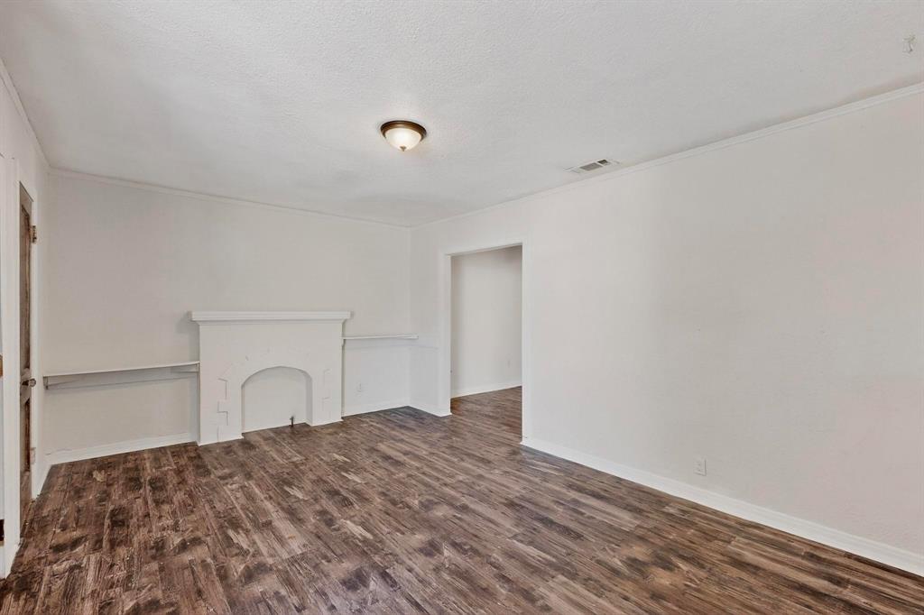 5020 Pershing Street Dallas, TX 75206 - Photo 8 of 30 a bedroom with a bed and a dresser