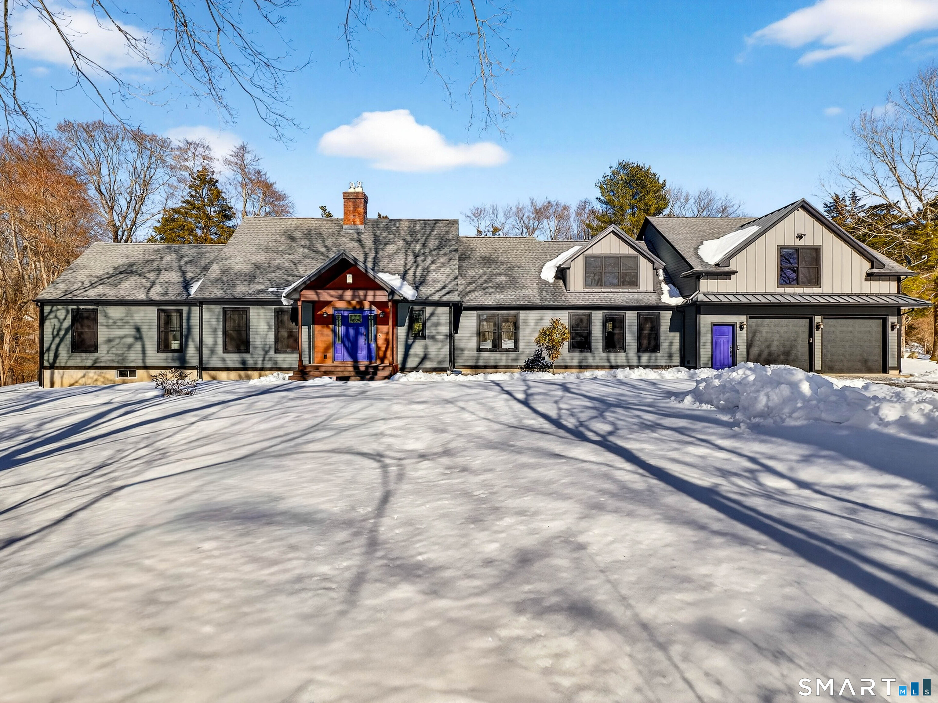 a view of a big house with large windows and a palm tree