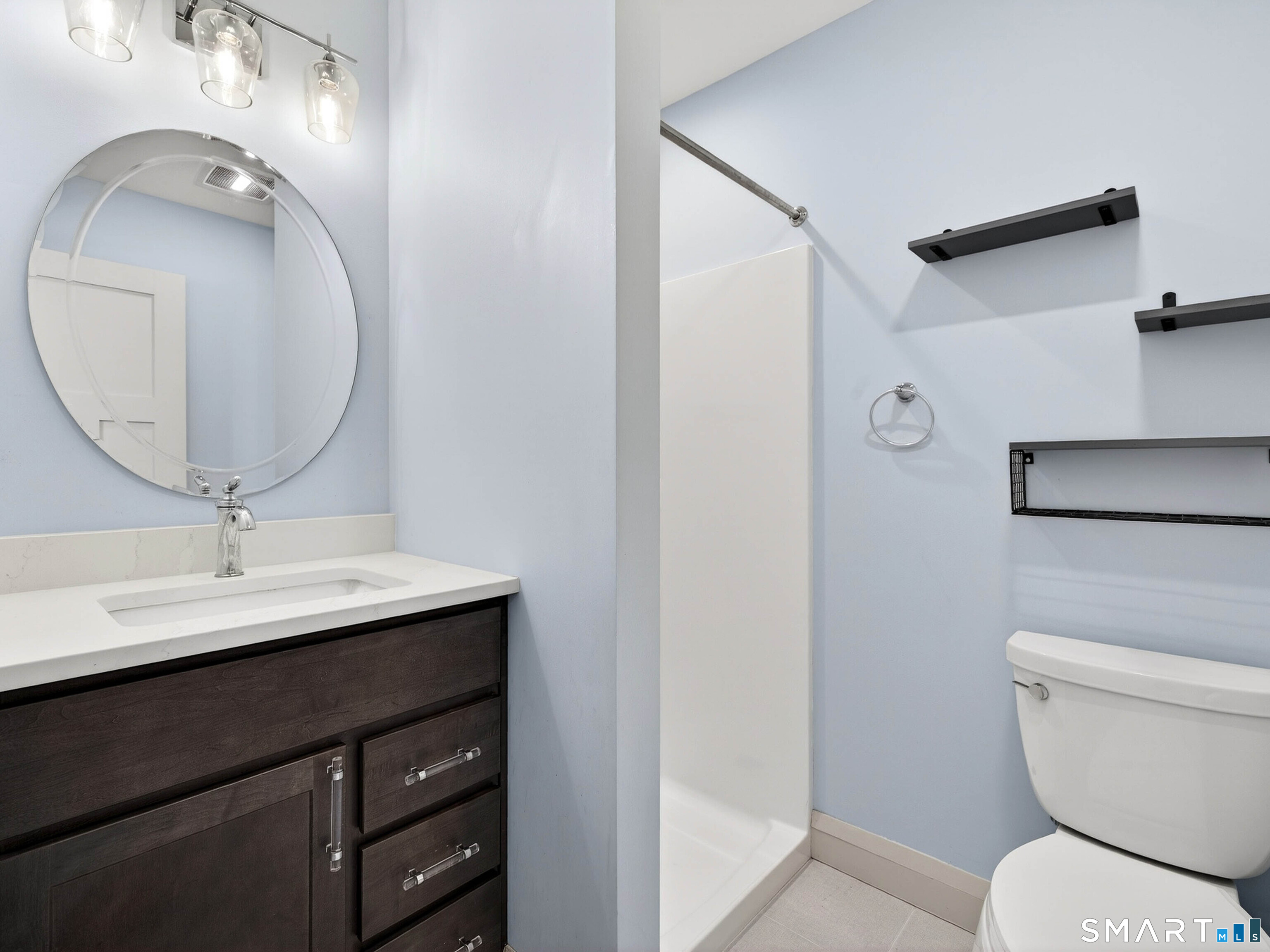 34-1 Johnny Cake Hill Road Old Lyme, CT 06371 - Photo 38 of 40 a bathroom with a toilet a sink and mirror