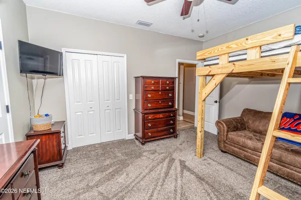 a bedroom with a bed and a baby crib