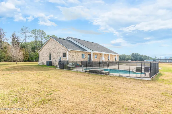 a view of a house with swimming pool and a yard