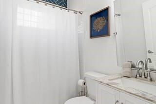 786 Peeples Street Southwest Atlanta, GA 30310 - Photo 13 of 14 a bathroom with a granite countertop sink mirror vanity and toilet
