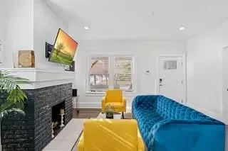 a living room with furniture and a fireplace