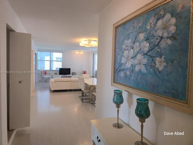 a living room with furniture and a mirror