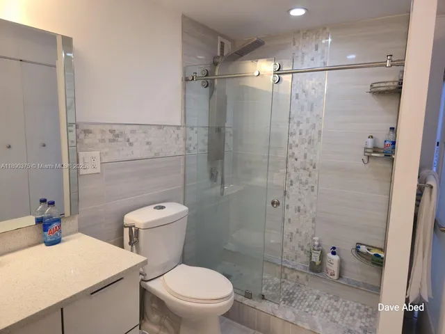 a bathroom with a toilet sink and shower