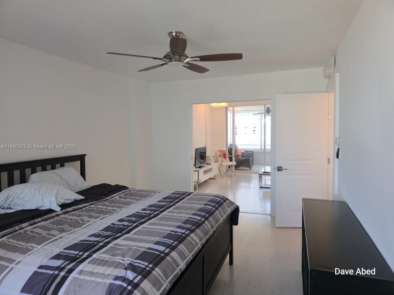 3600 Galt Ocean Drive, Unit 14C Fort Lauderdale, FL 33308 - Photo 12 of 22 a bedroom with a bed and a chandelier