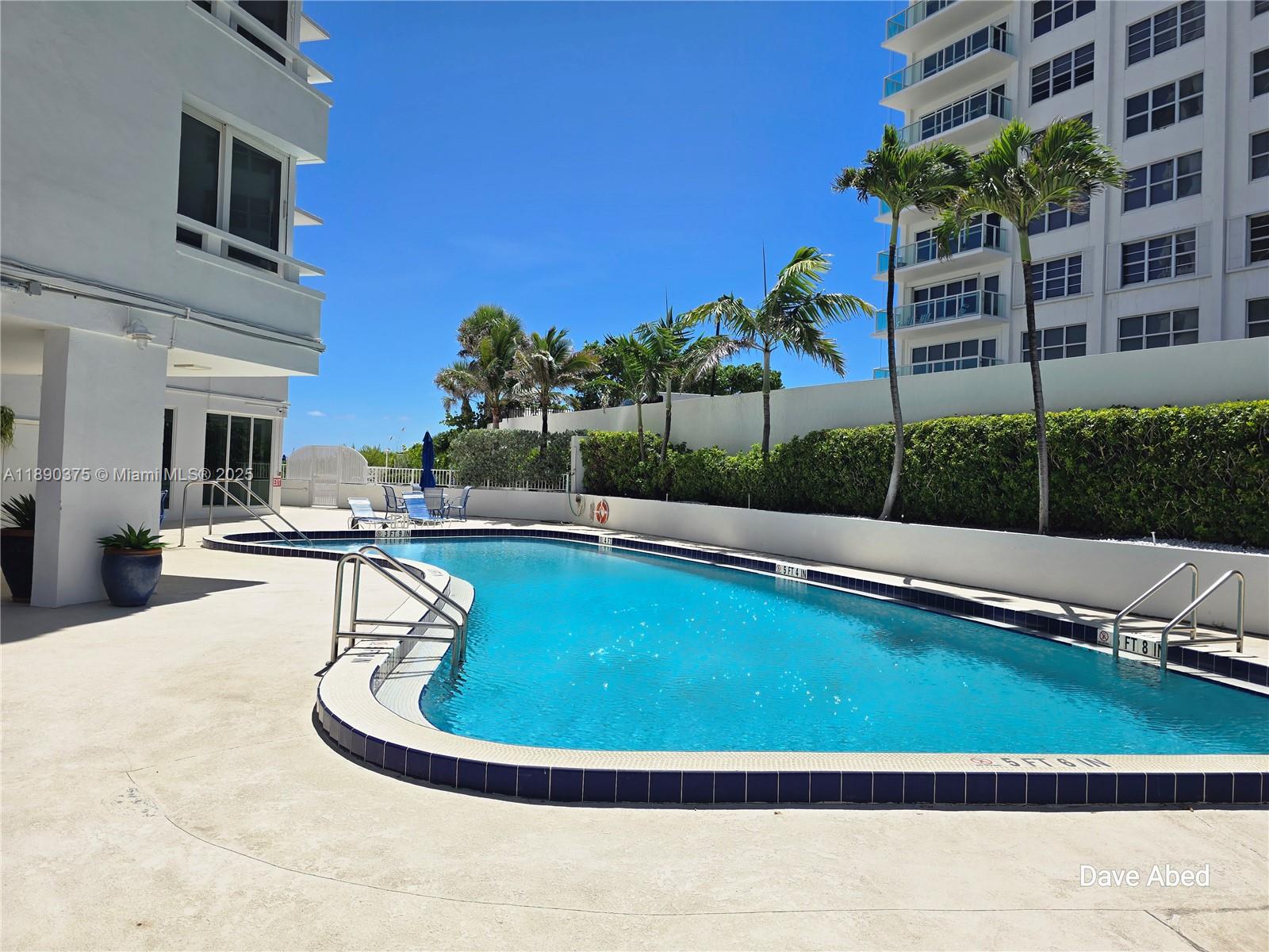3600 Galt Ocean Drive, Unit 14C Fort Lauderdale, FL 33308 - Photo 20 of 22 a view of a swimming pool with a lounge chairs