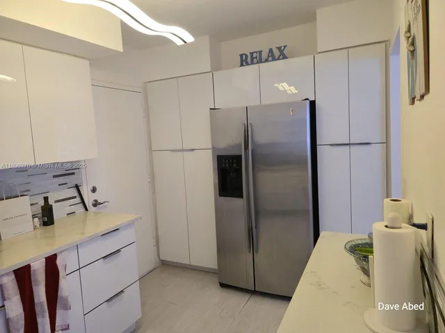 a kitchen with a refrigerator and countertop