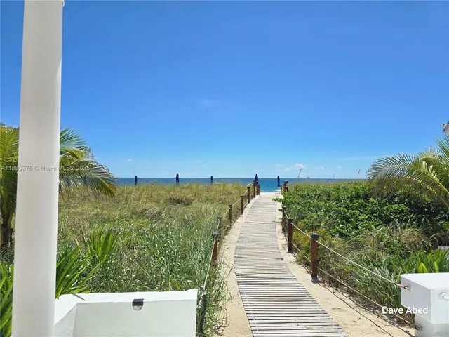 a lobby with furniture and a potted plant