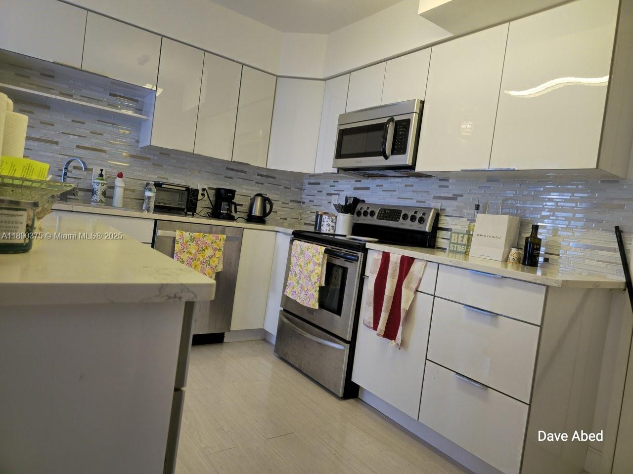 3600 Galt Ocean Drive, Unit 14C Fort Lauderdale, FL 33308 - Photo 4 of 22 a kitchen with appliances a sink and cabinets