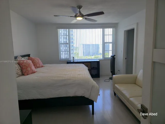 a bedroom with a bed couch and window