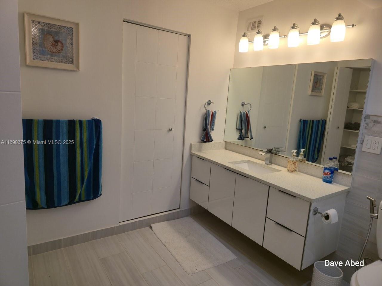 3600 Galt Ocean Drive, Unit 14C Fort Lauderdale, FL 33308 - Photo 10 of 22 a bathroom with a double vanity sink and a mirror