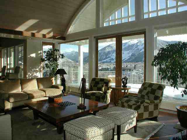 1230 Willoughby Way Aspen, CO 81612 - Photo 2 of 6 a living room with furniture and a floor to ceiling window