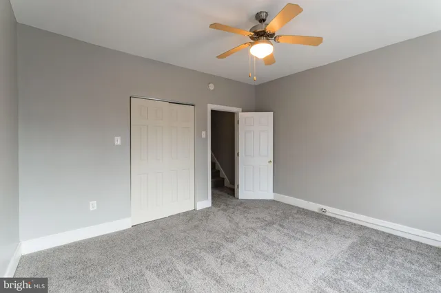 a view of an empty room with a fan
