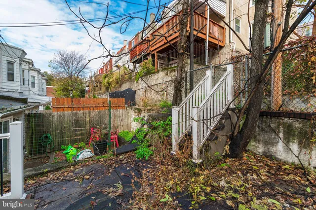 a view of a house with a yard and a patio