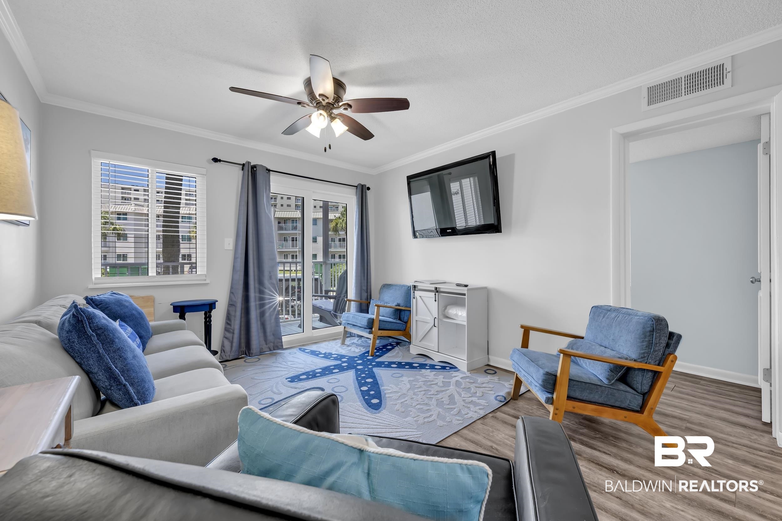 400 Plantation Road, Unit 2118 Gulf Shores, AL 36542 - Photo 4 of 59 Living area featuring wood-finish flooring, a ceiling fan, and crown molding