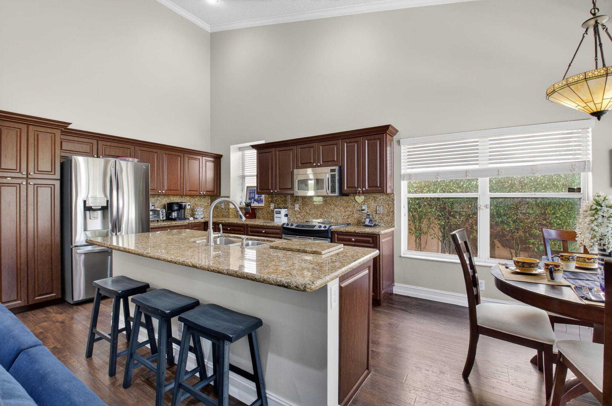 8361 Horseshoe Bay Road Boynton Beach, FL 33472 - Photo 17 of 73 a kitchen with granite countertop lots of counter top space and stainless steel appliances