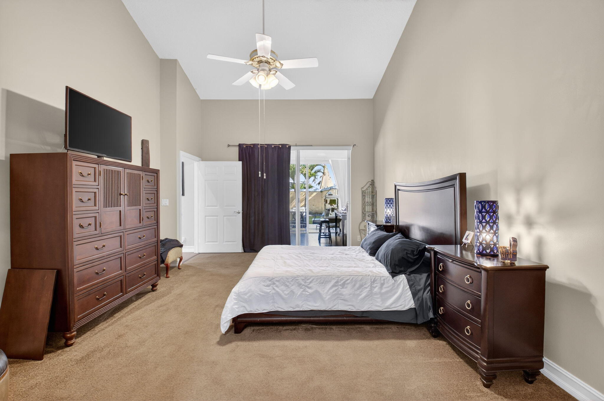 8361 Horseshoe Bay Road Boynton Beach, FL 33472 - Photo 27 of 73 a bedroom with a bed and a flat tv screen on dresser
