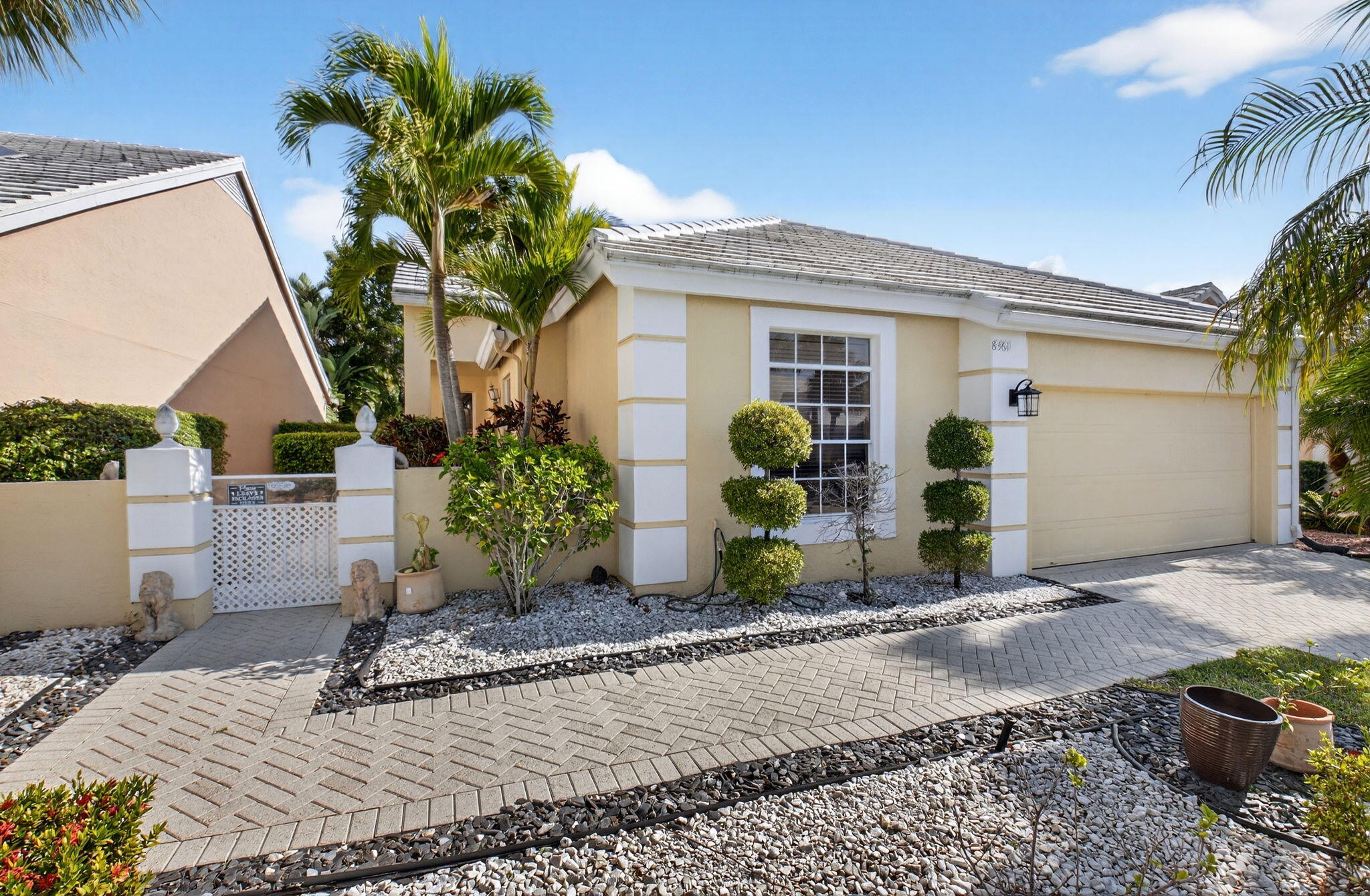 8361 Horseshoe Bay Road Boynton Beach, FL 33472 - Photo 4 of 73 a front view of a house with garden