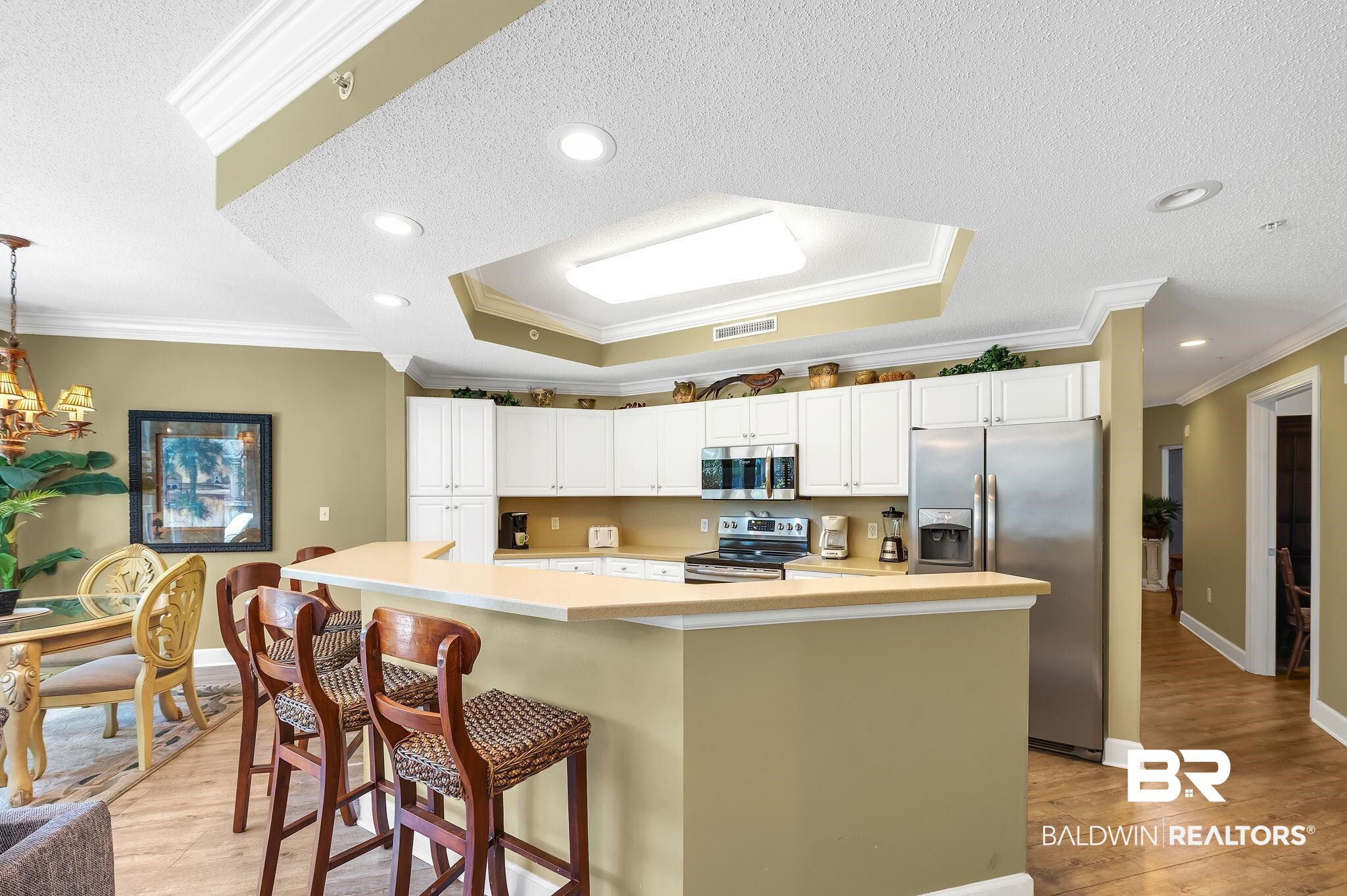 27580 Canal Road, Unit 1214 AND BOAT SLIP #62 Orange Beach, AL 36561 - Photo 15 of 67 Kitchen featuring light wood-style floors, ornamental molding, white cabinets, and stainless steel appliances