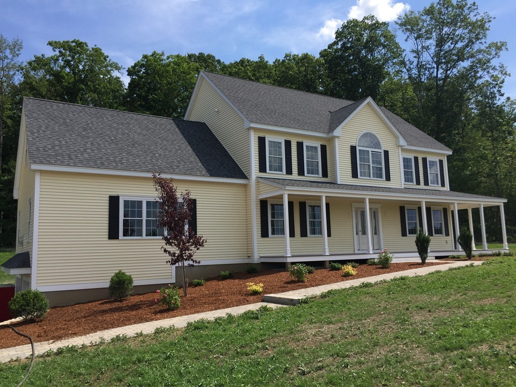 6 Quail Ridge Road Merrimac, MA 01860 - Photo 1 of 10 a front view of a house with a yard table and chairs
