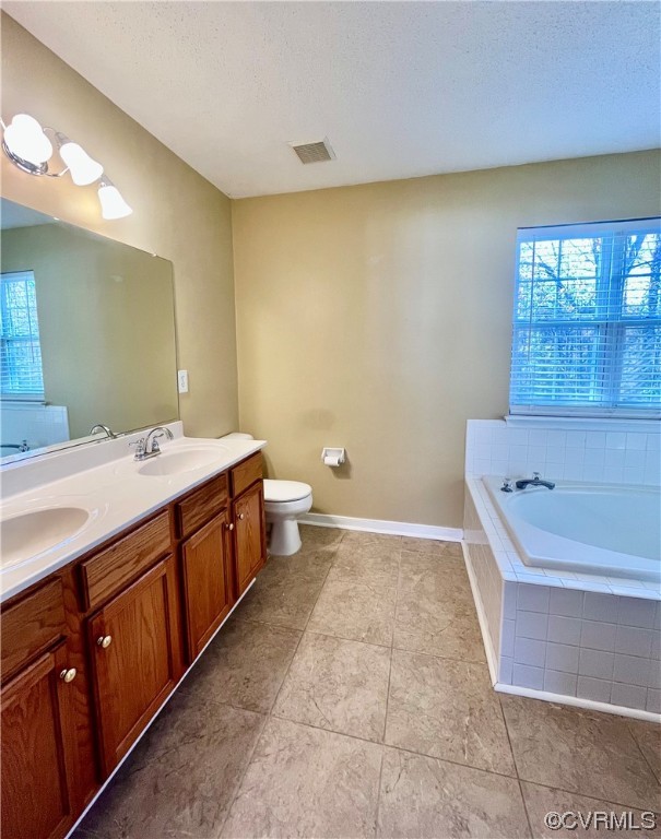 1023 Bogart Road Richmond, VA 23223 - Photo 24 of 40 a spacious bathroom with a tub sink and mirror