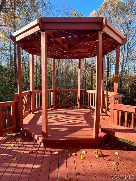 1023 Bogart Road Richmond, VA 23223 - Photo 27 of 40 a view of a patio with table and chairs a barbeque with wooden floor and roof
