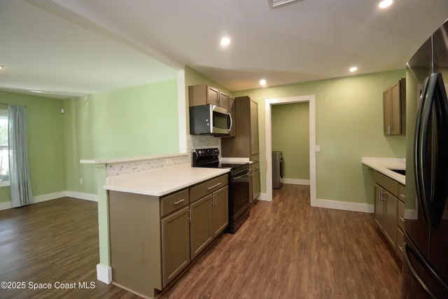 a kitchen with a sink stove and refrigerator