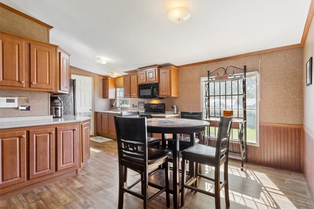 4517 Rocking K Drive Waco, TX 76705 - Photo 7 of 25 a kitchen with stainless steel appliances kitchen island granite countertop a dining table chairs and a refrigerator