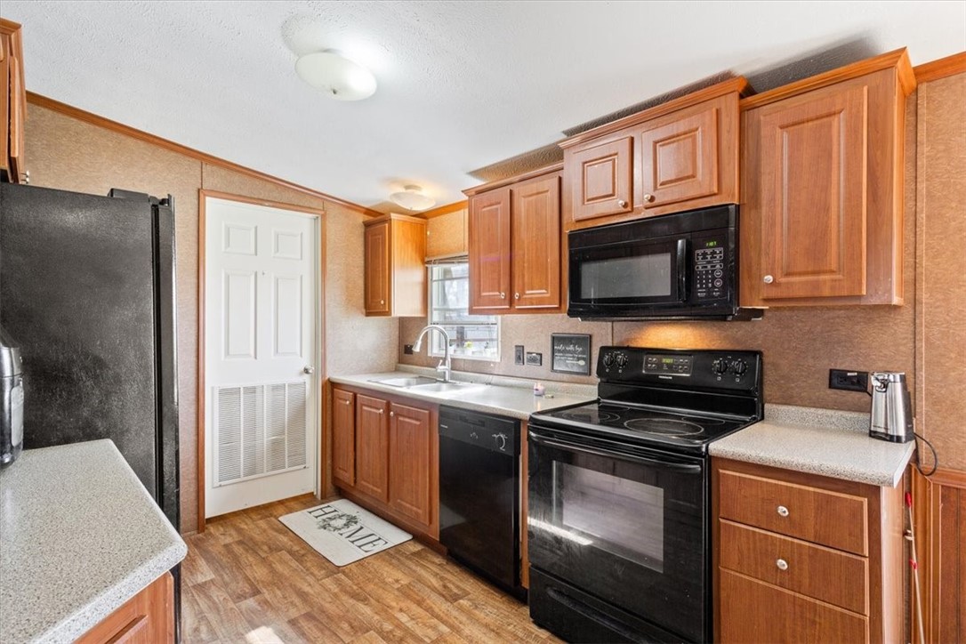 4517 Rocking K Drive Waco, TX 76705 - Photo 8 of 25 a kitchen with stainless steel appliances granite countertop a stove microwave refrigerator sink and cabinets