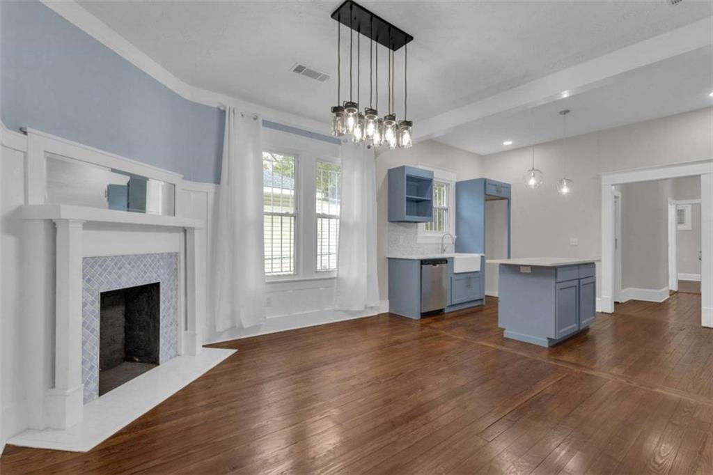 1286 Allene Avenue Southwest Atlanta, GA 30310 - Photo 11 of 49 a view of an empty room and kitchen with fireplace wooden floor