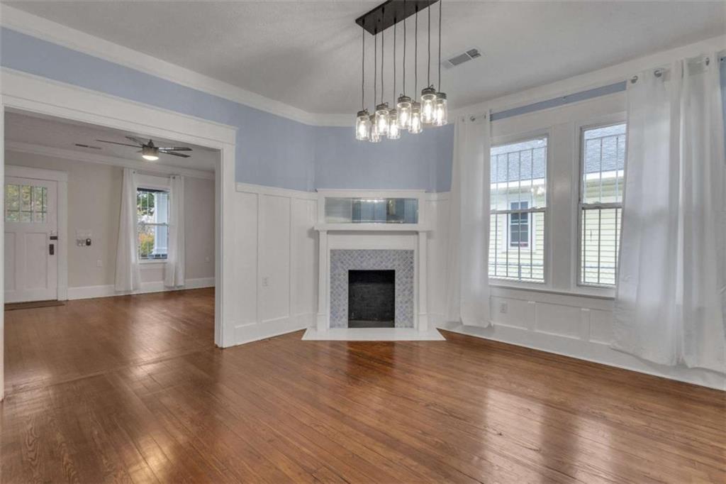 1286 Allene Avenue Southwest Atlanta, GA 30310 - Photo 12 of 49 a view of an empty room with wooden floor fireplace and a window
