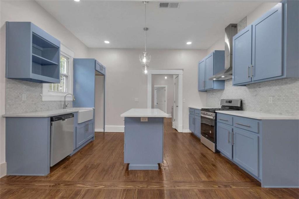 1286 Allene Avenue Southwest Atlanta, GA 30310 - Photo 14 of 49 a large kitchen with stainless steel appliances kitchen island granite countertop a stove a sink a refrigerator and a microwave