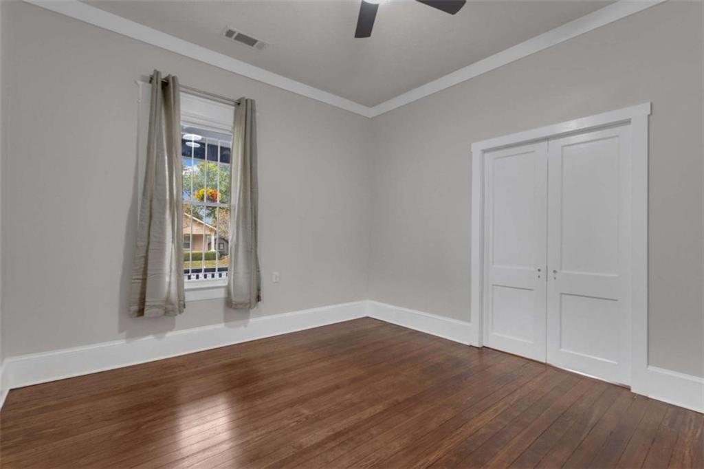 1286 Allene Avenue Southwest Atlanta, GA 30310 - Photo 22 of 49 a view of an empty room with wooden floor and a window