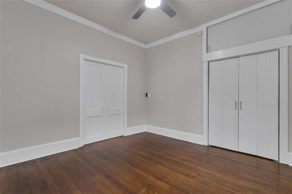 1286 Allene Avenue Southwest Atlanta, GA 30310 - Photo 23 of 49 a view of an empty room with wooden floor closet and chandelier fan