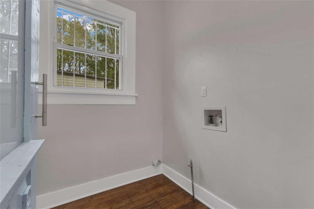 1286 Allene Avenue Southwest Atlanta, GA 30310 - Photo 30 of 49 a view of an empty room with wooden floor and a window