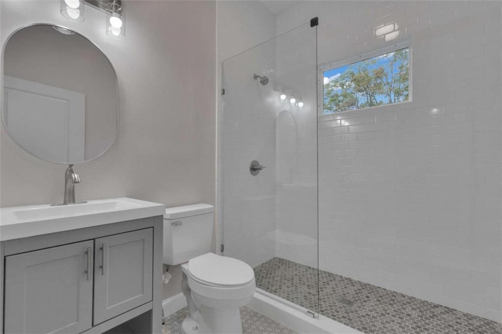 1286 Allene Avenue Southwest Atlanta, GA 30310 - Photo 34 of 49 a bathroom with a sink a toilet and shower
