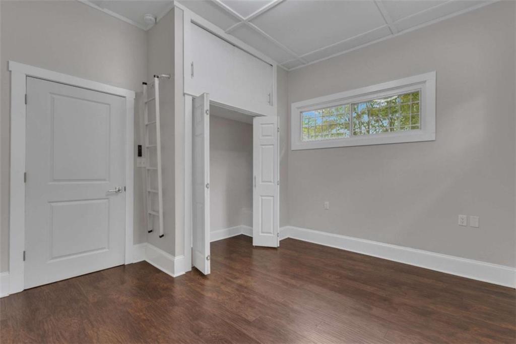 1286 Allene Avenue Southwest Atlanta, GA 30310 - Photo 36 of 49 an empty room with wooden floor and windows