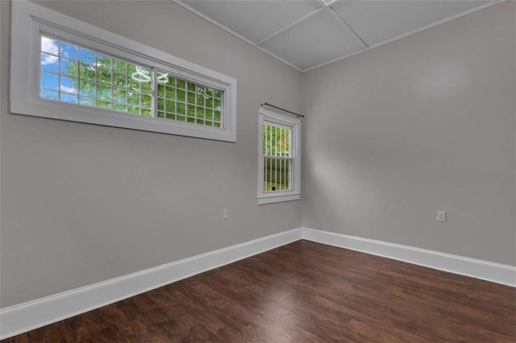 1286 Allene Avenue Southwest Atlanta, GA 30310 - Photo 38 of 49 a view of an empty room with wooden floor and a window