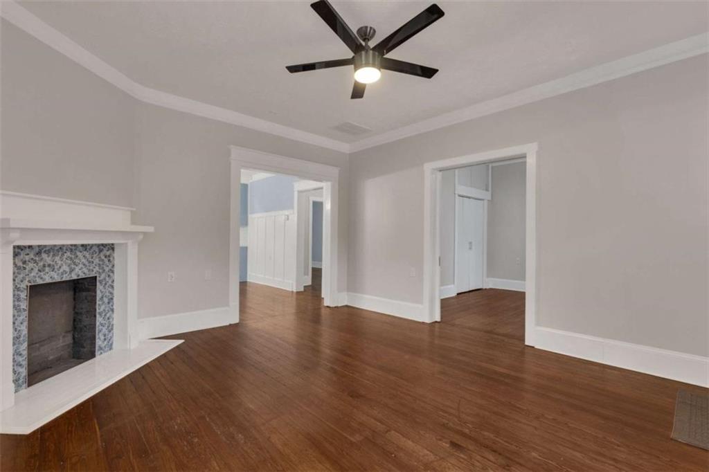 1286 Allene Avenue Southwest Atlanta, GA 30310 - Photo 9 of 49 a view of an empty room with wooden floor and a fireplace