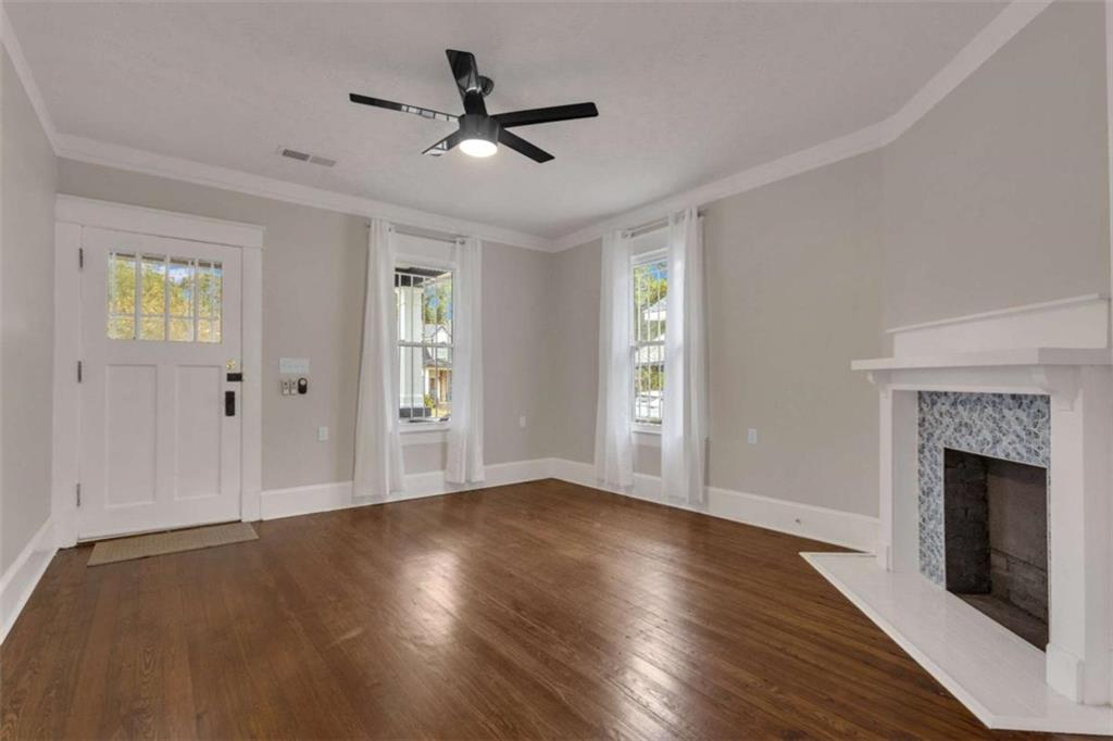 1286 Allene Avenue Southwest Atlanta, GA 30310 - Photo 10 of 49 a view of an empty room with wooden floor and a window