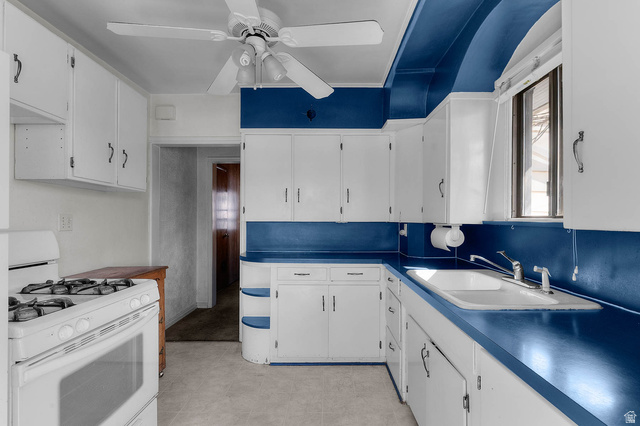 7689 Locust Street Midvale, UT 84047 - Photo 5 of 26 Kitchen featuring white gas stove, white cabinets, and ceiling fan.