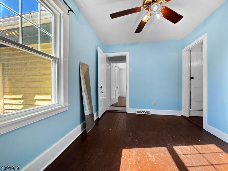 54 Front Street Belvidere, NJ 07823 - Photo 21 of 32 a view of an empty room with wooden floor and a window
